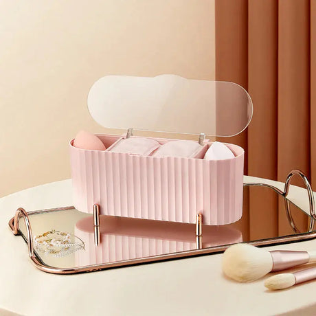 a pink makeup case with a mirror and brush