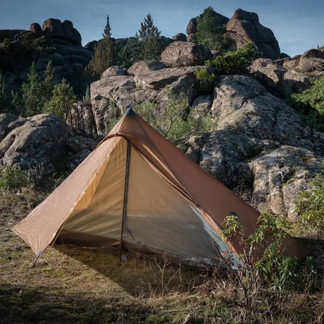 a tent pitched on a rocky mountain