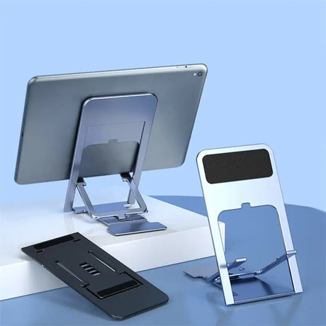 a computer, tablet and phone stand on a desk