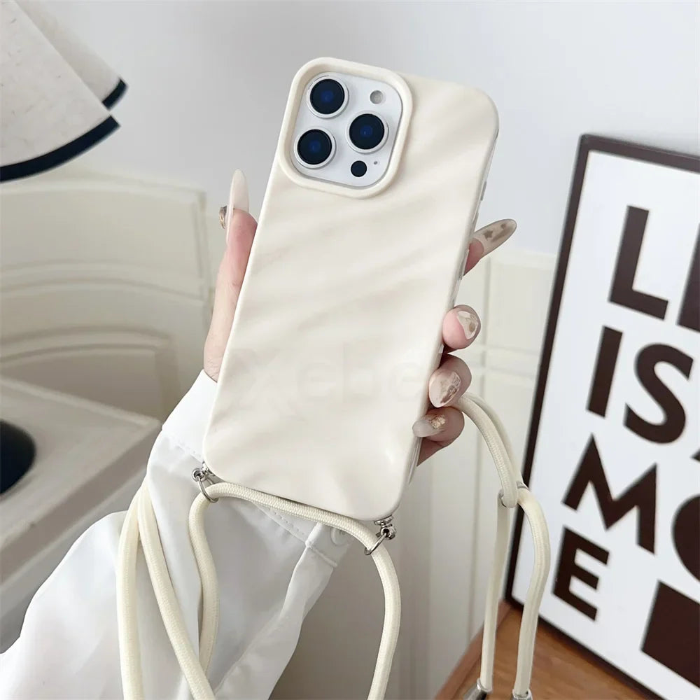Cream-colored phone case with lanyard.