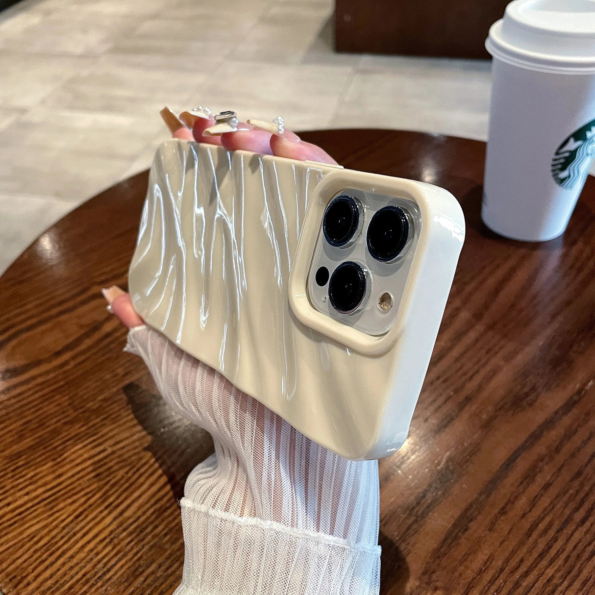 Cream-colored phone case with wavy design.