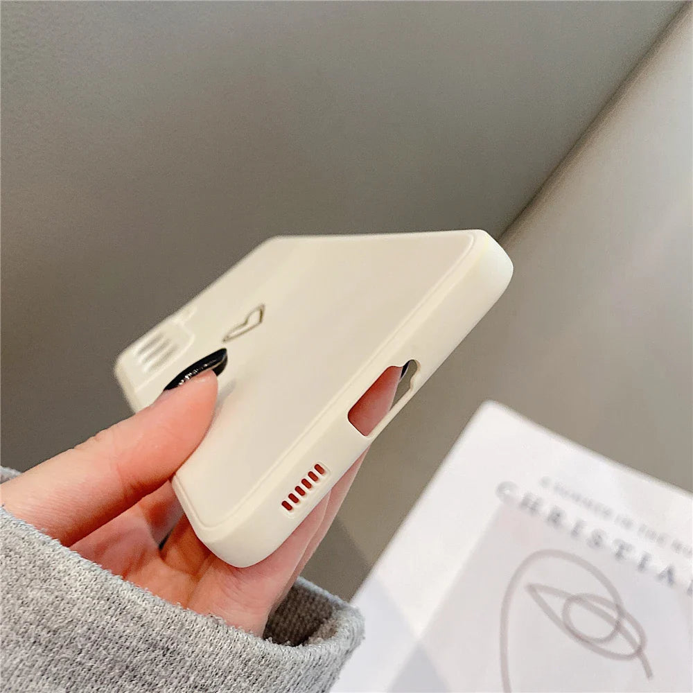A creamy white silicone phone case with a small heart outline and a ribbed detail.