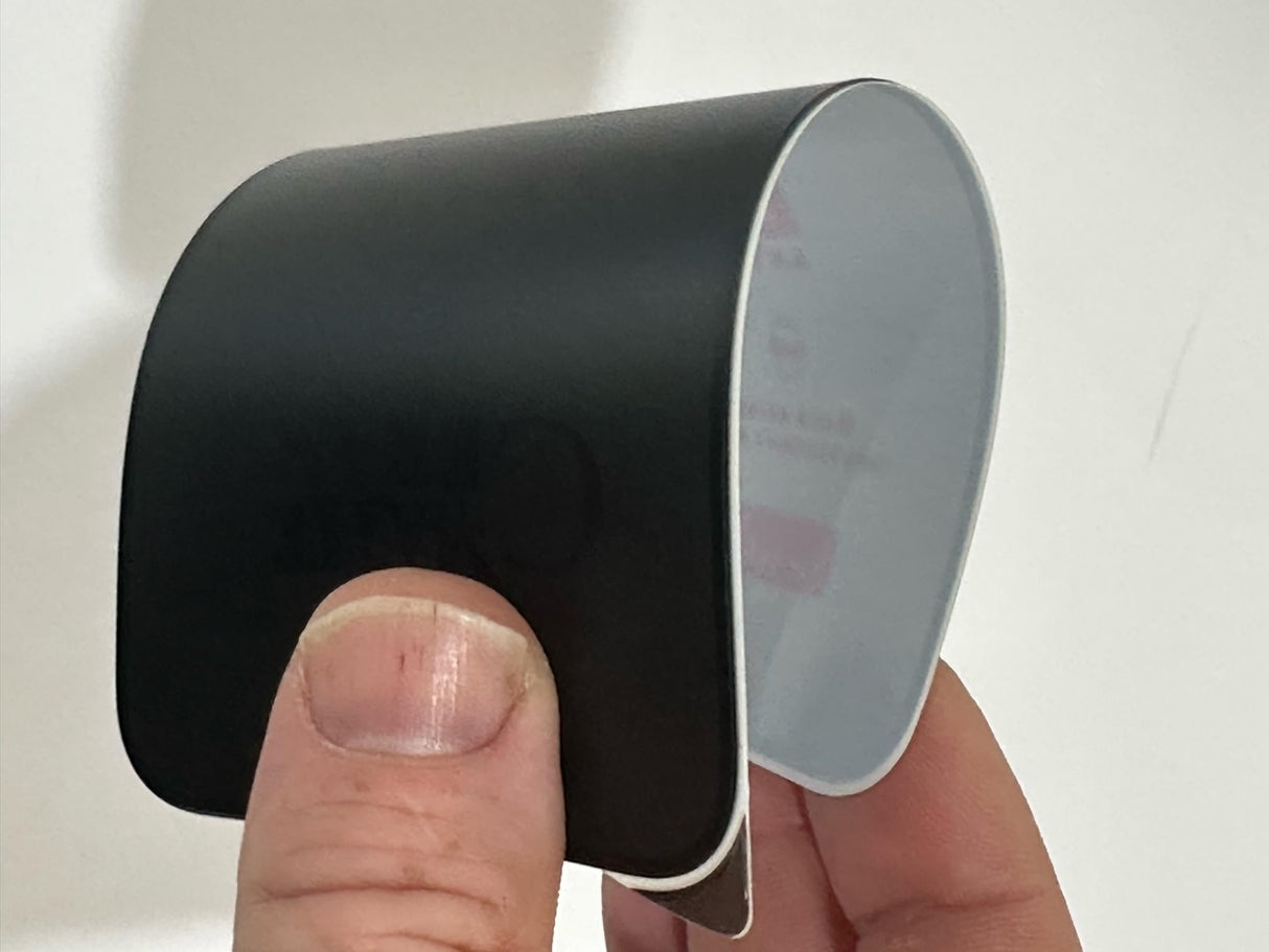 Curved black and white adhesive strip.