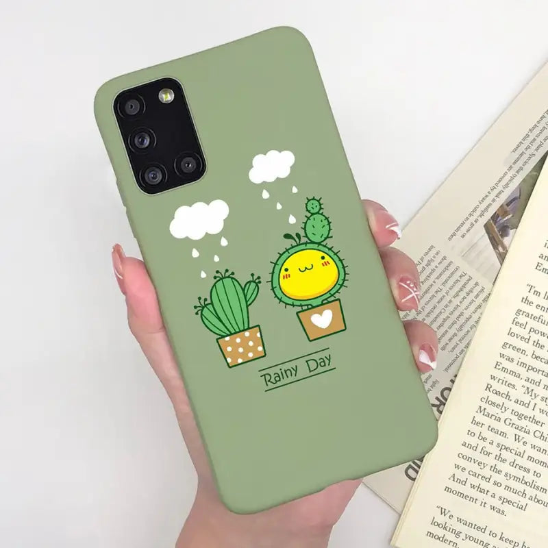 a woman holding a green phone case with a cactus plant