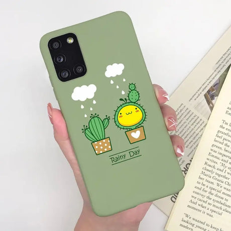 a woman holding a green phone case with a cactus plant