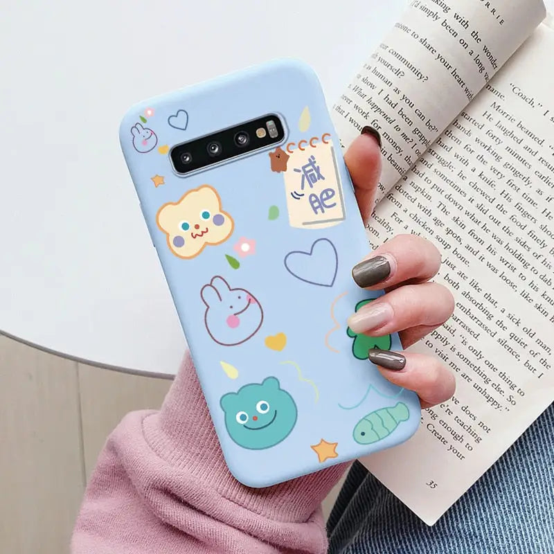 a woman holding a phone case with a pattern of animals and birds
