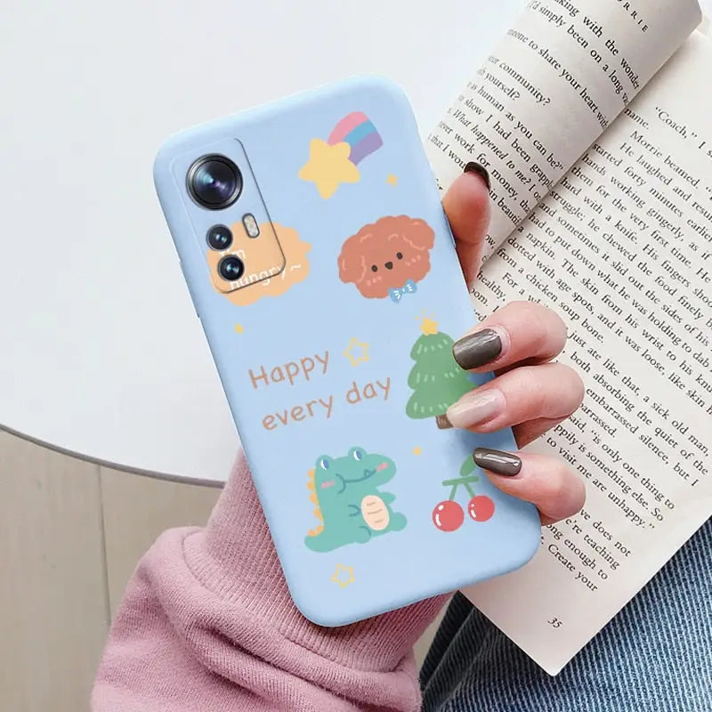 a woman holding a phone case with a cartoon design