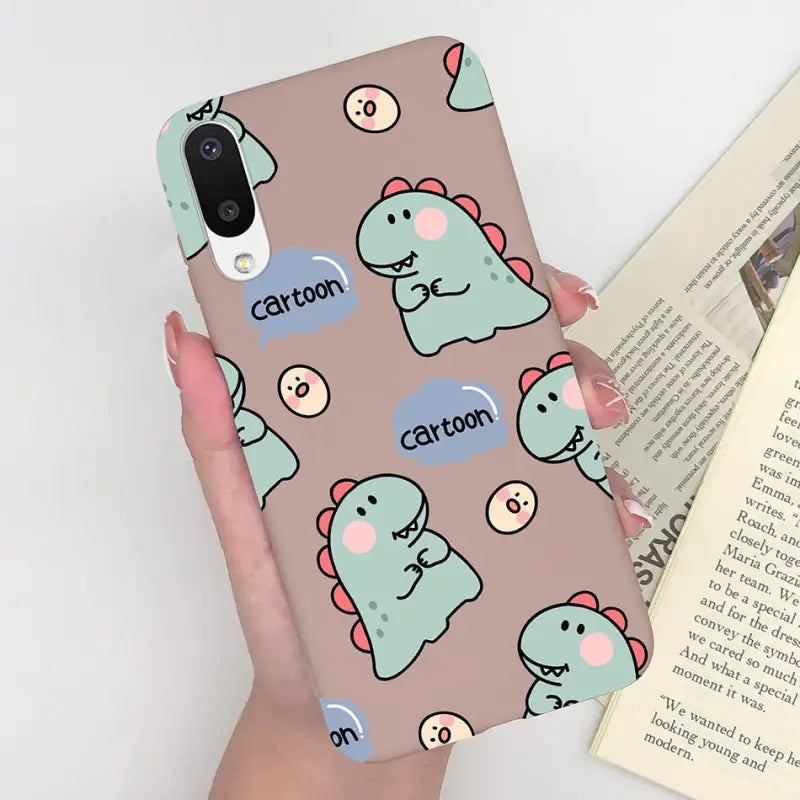 a woman holding a phone case with a pattern of cats