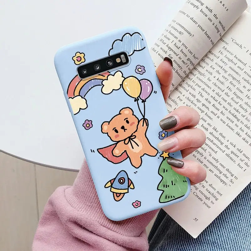 a woman holding a phone case with a cartoon character on it