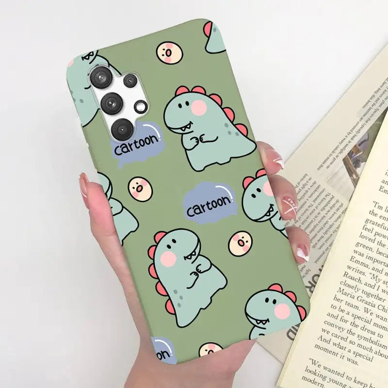 someone holding a phone case with a cartoon dinosaur design on it