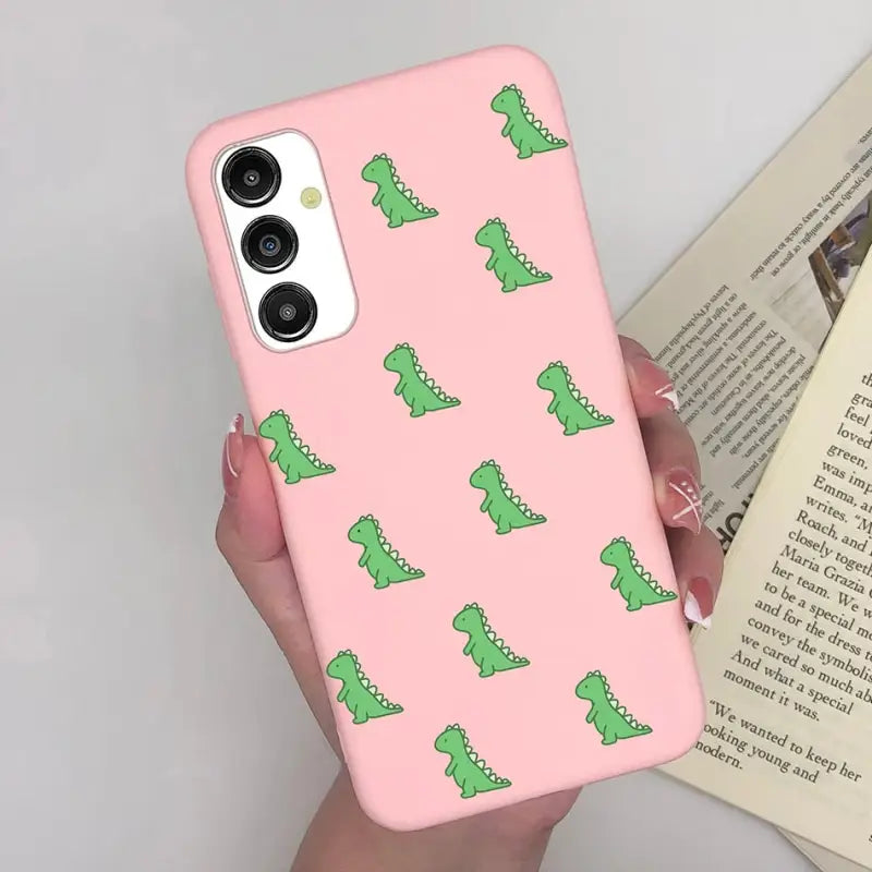 a pink phone case with green alligators on it