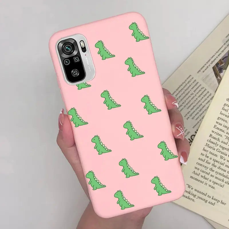a pink phone case with green alligators on it