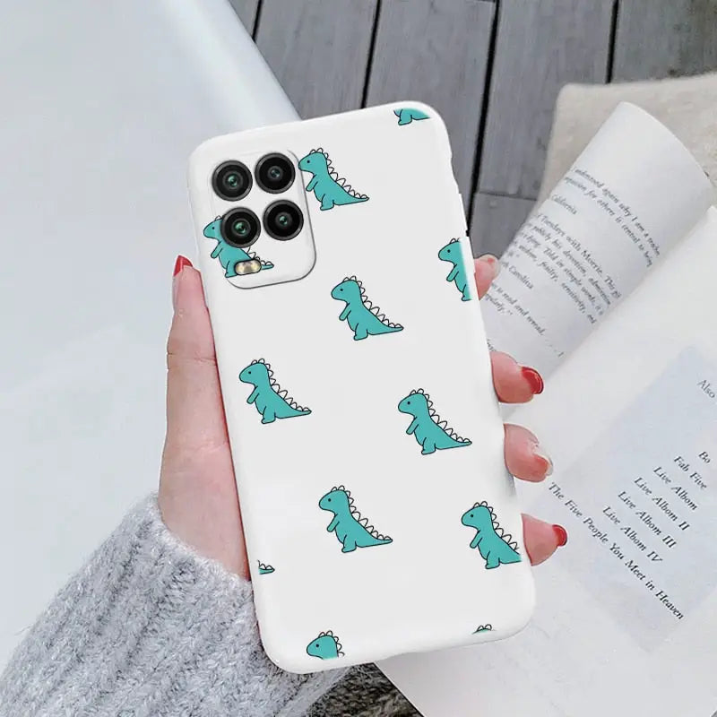a woman holding a phone case with a green dinosaur pattern