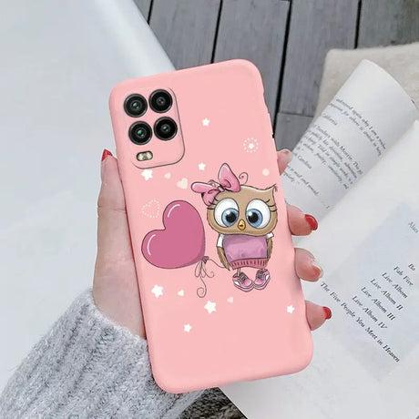 a girl holding a pink phone case with a cute owl on it