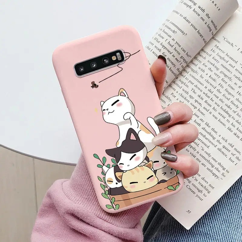 a woman holding a phone case with a cat on it