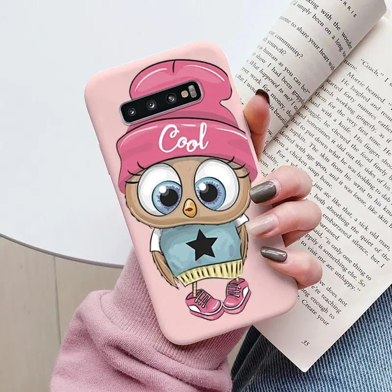 a girl with a pink hat and a pink cap on her head, holding a pink phone case