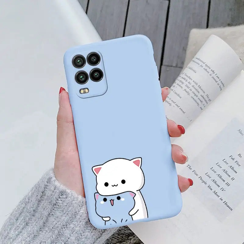 a woman holding a phone case with a cat on it