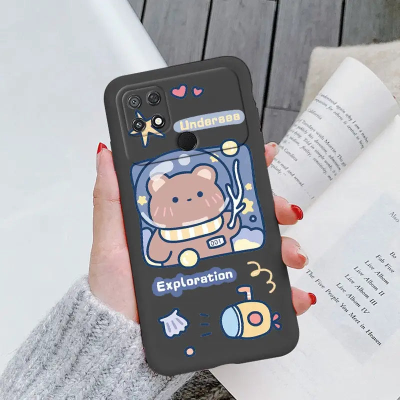 a woman holding a phone case with a cartoon character