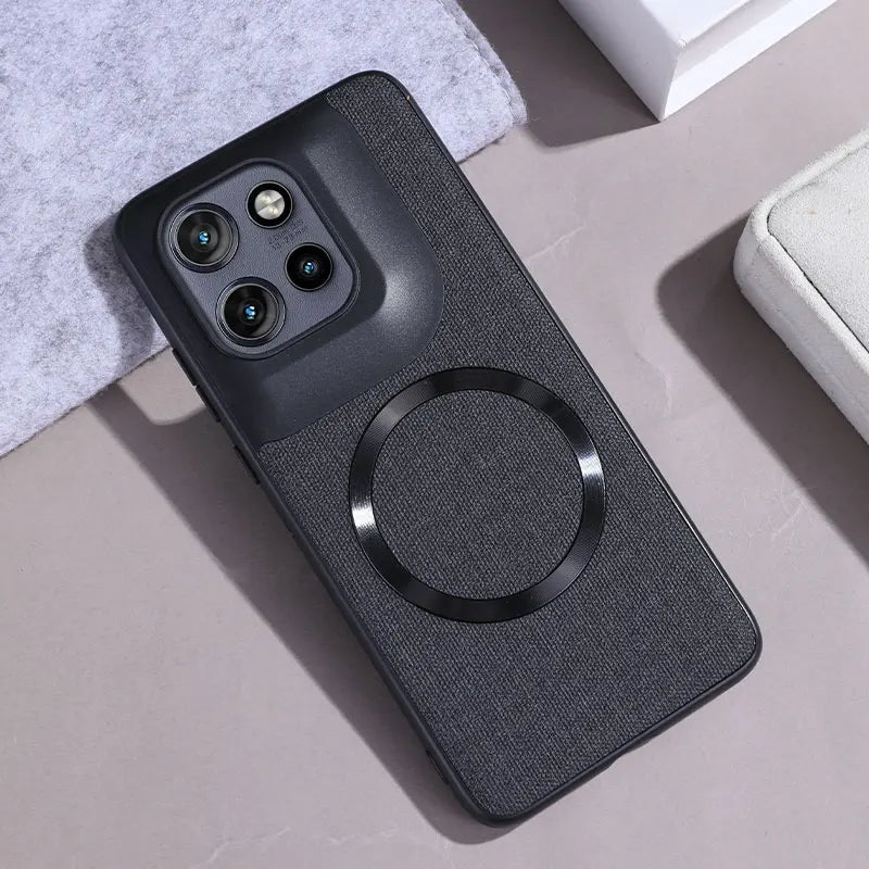 Dark gray fabric-textured phone case with a raised camera module and an embedded black magnetic ring.