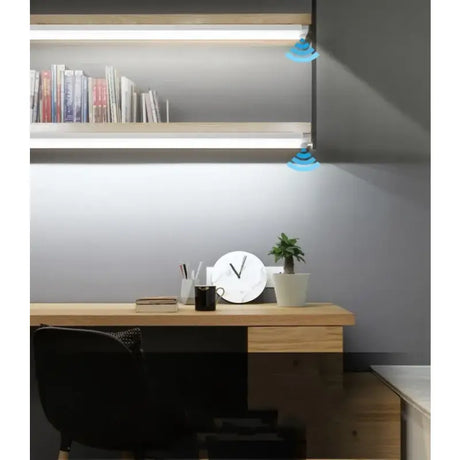 A desk with a lamp and a chair
