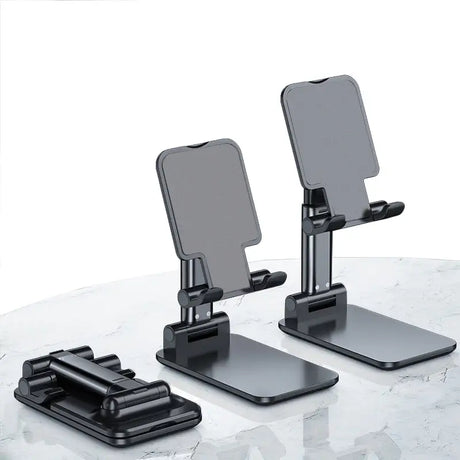 there are two cell phones on a table with a mirror