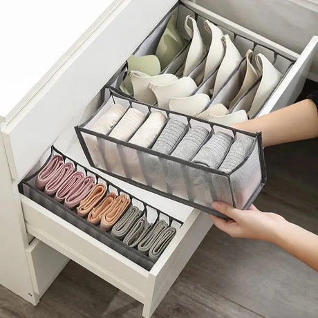 a woman holding a drawer with shoes in it