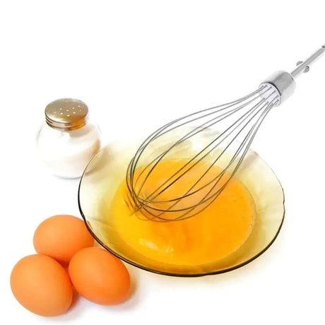eggs and a whisk in a bowl with a whisk on a table