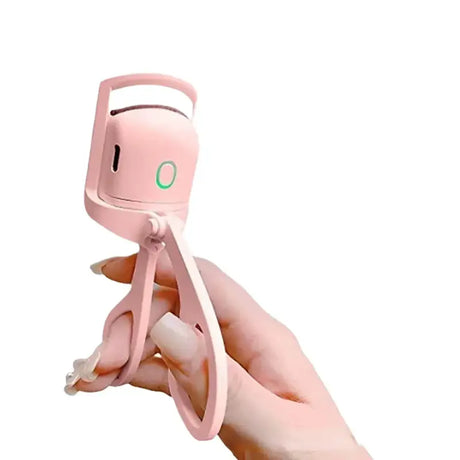 a hand holding a pink toy with a green button