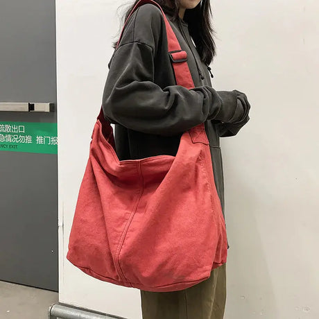 a woman wearing a red bag with a black hoodie