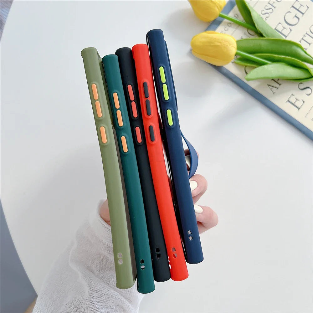 Five colorful silicone phone cases with contrasting buttons