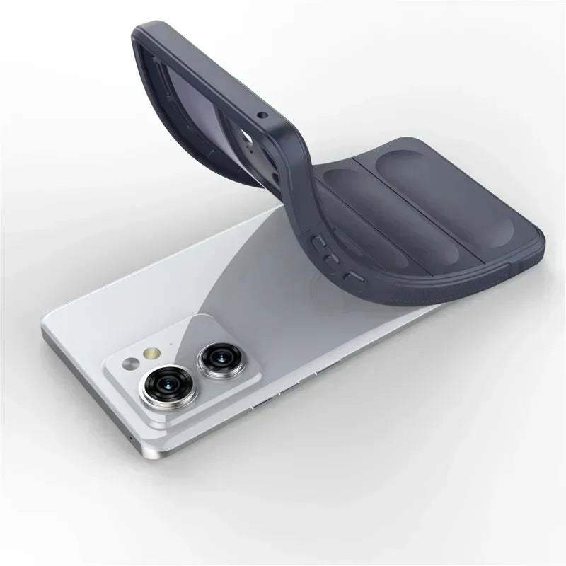 A flexible dark gray phone case being removed from or placed onto a white smartphone with two prominent cameras.