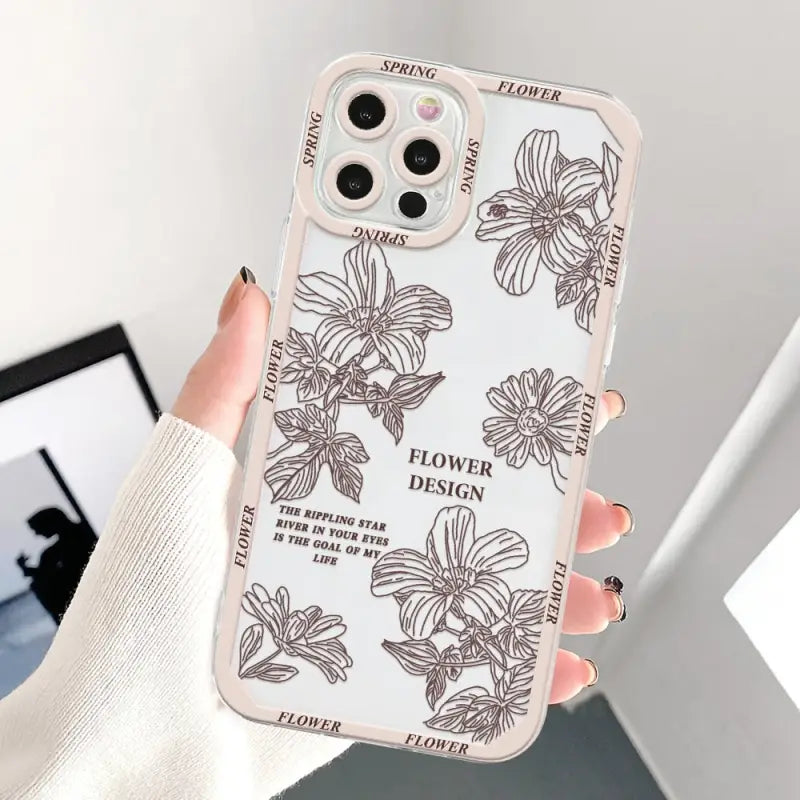 a woman holding a phone case with flowers on it