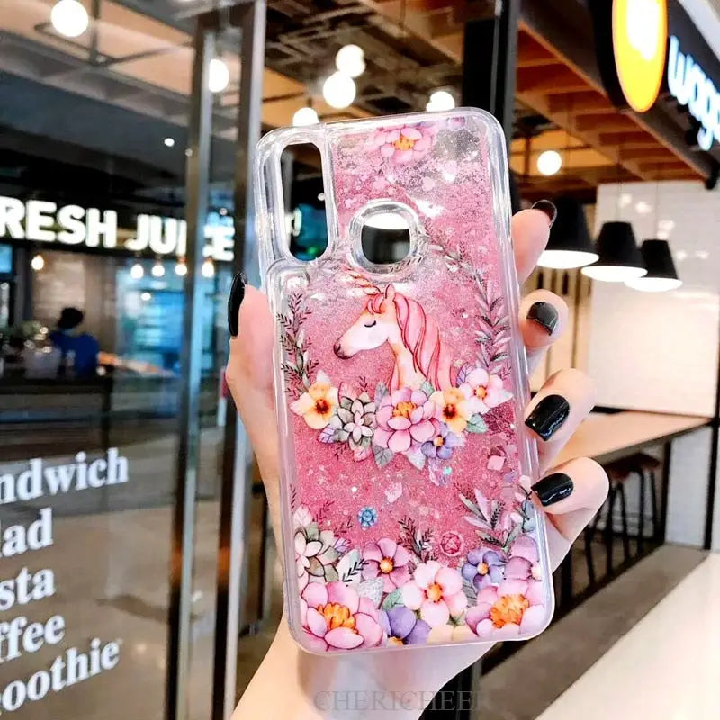 a woman holding a pink phone case with flowers on it