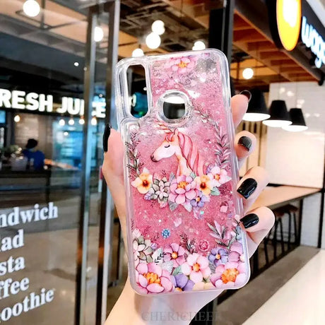 a woman holding a pink phone case with flowers on it