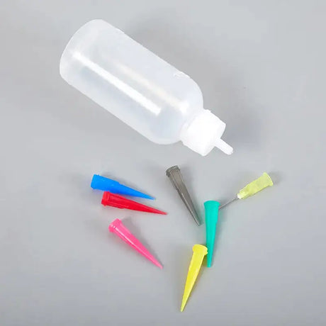 there are four different colored plastic toothbrushes and a bottle of toothpaste