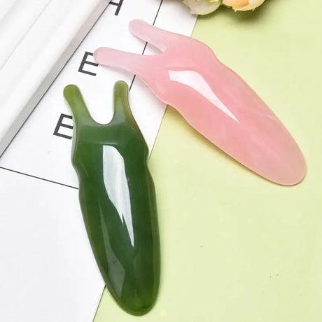 there are two plastic spoons sitting on a table next to a flower
