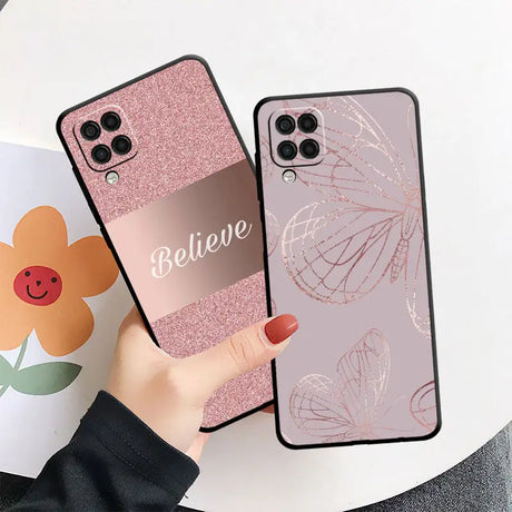 a woman holding a phone case with a pink glitter case