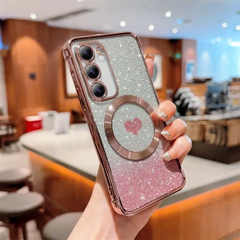 a woman holding up a pink glitter iphone case