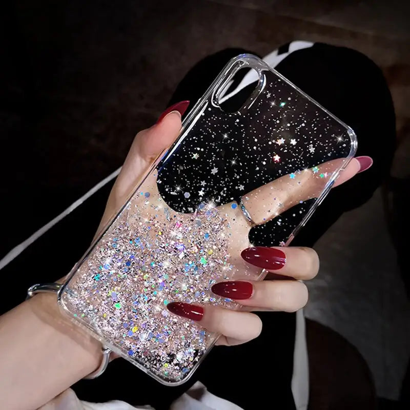 a woman holding a phone case with glitter