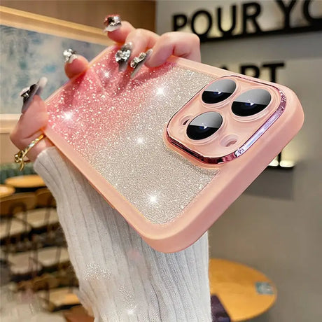 a woman holding a phone case with a pink glitter case