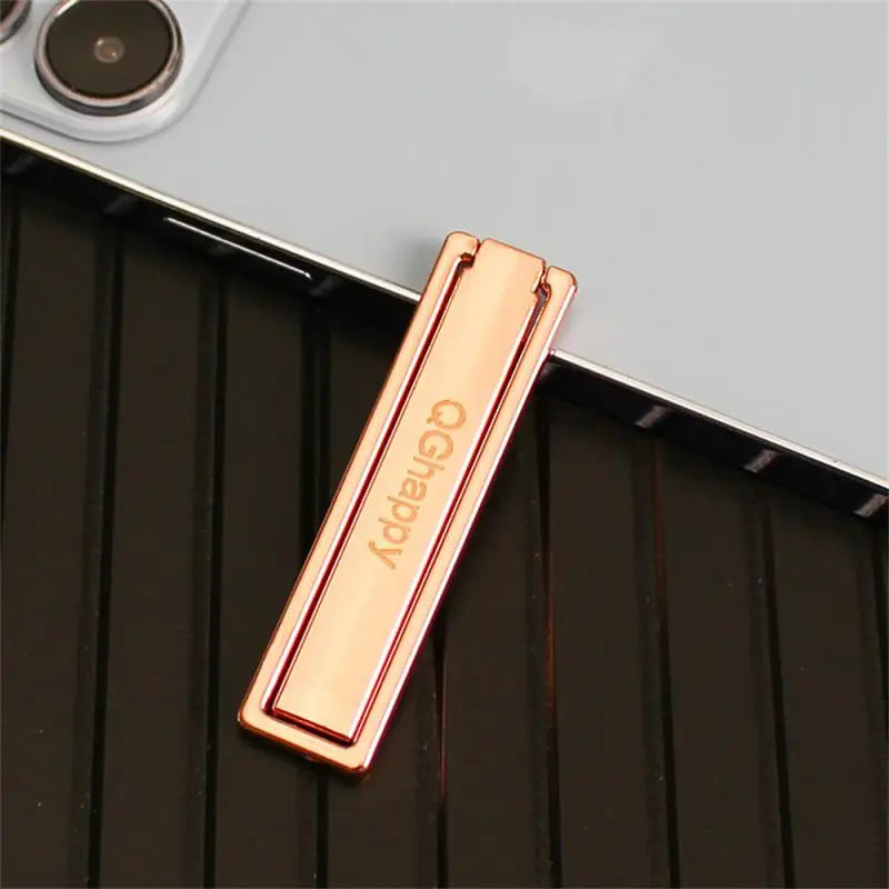a gold bar on a black surface