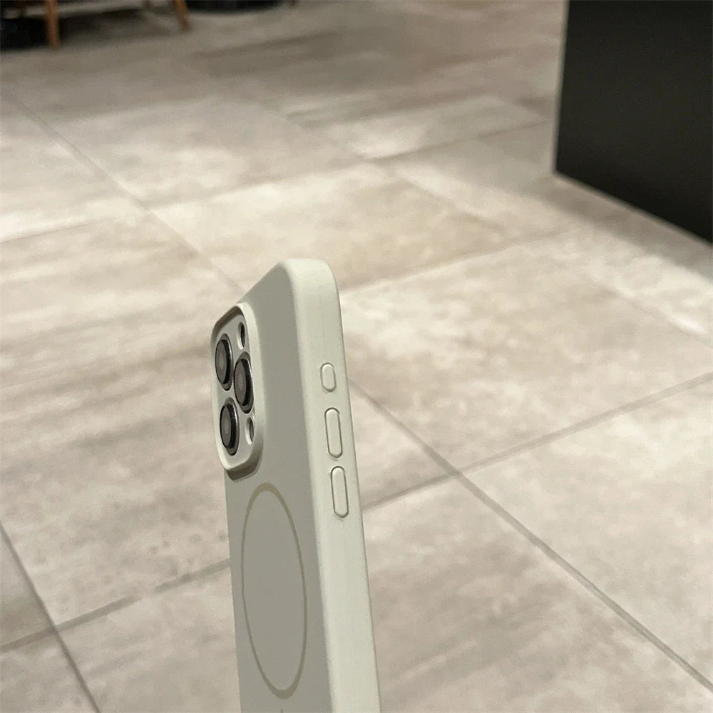 Gray smartphone with camera array and MagSafe ring.