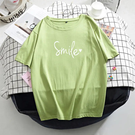 a green t shirt with the word smile on it