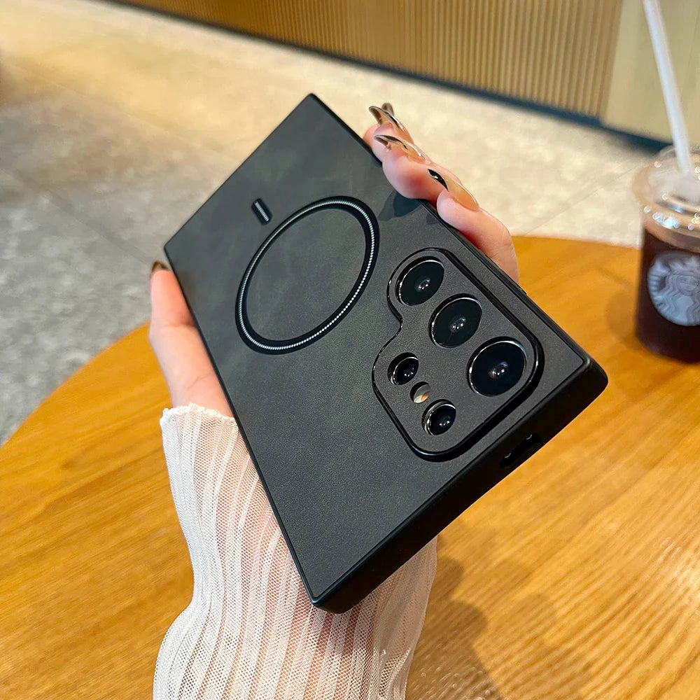 a hand holding a black phone case with a camera