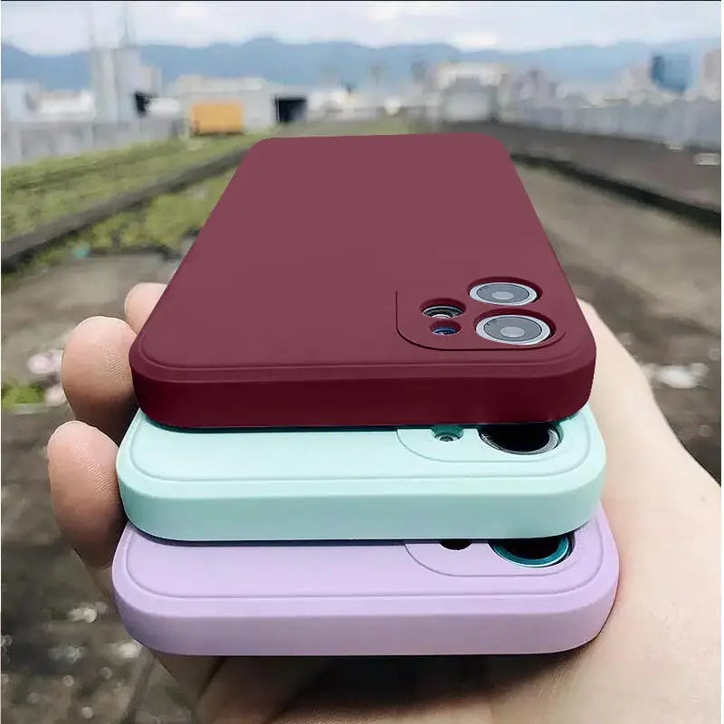 A hand holding a phone case with a camera