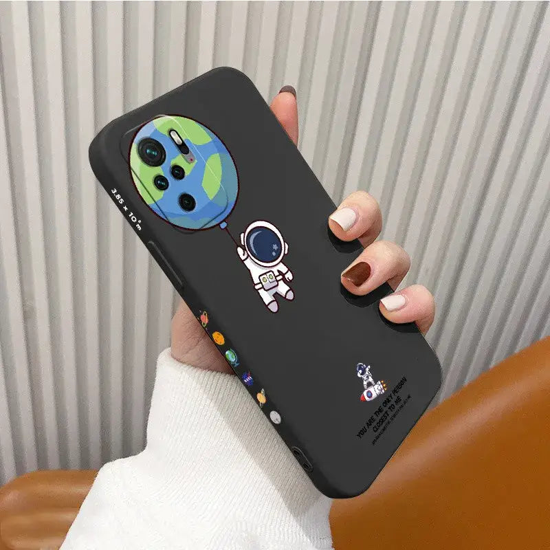 A hand holding a phone case with a cartoon character on it