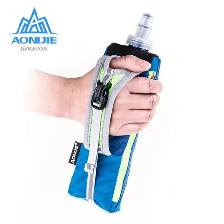 a hand holding a water bottle with a blue and green cover