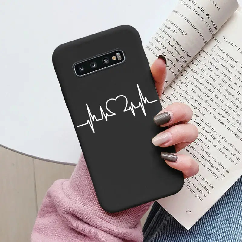 a woman holding a book and a phone case