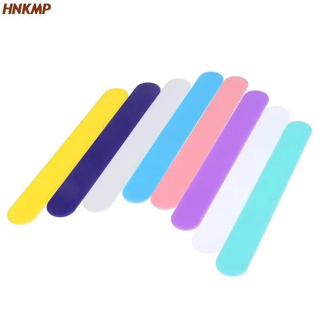 a close up of a group of different colored nail files