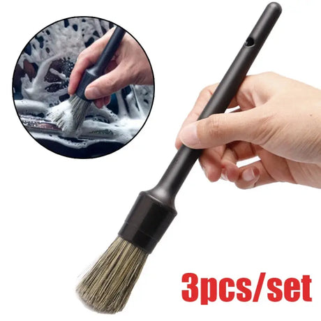 a hand holding a brush with a white background